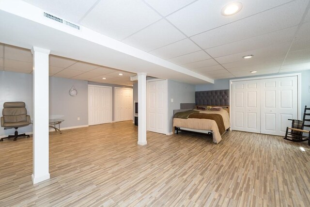 113 Sparrow Rd, Stoughton, MA 02072 - bedroom featuring a drop ceiling, light wood-style floors, recessed lighting, and two closets