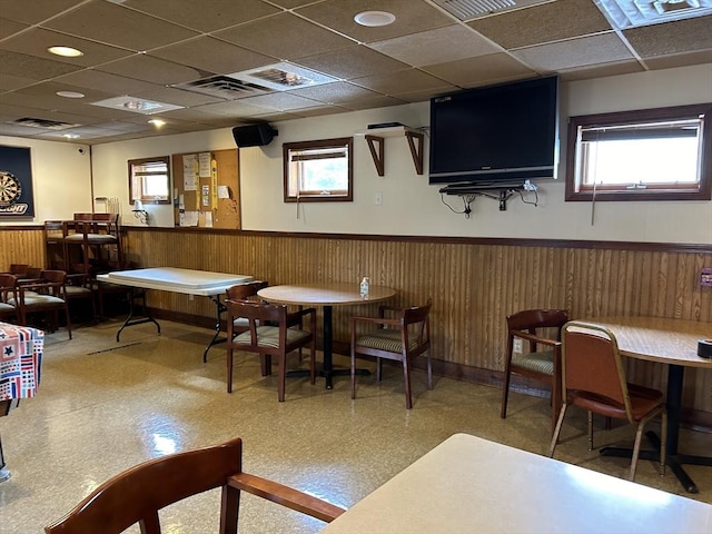 recreation room with wooden walls, wainscoting, a paneled ceiling, and tile patterned floors