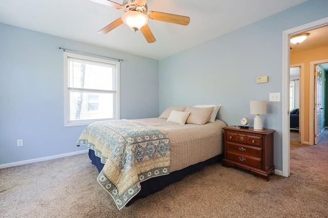 carpeted bedroom featuring baseboards and ceiling fan