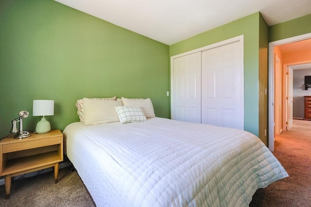 carpeted bedroom with a closet and lofted ceiling
