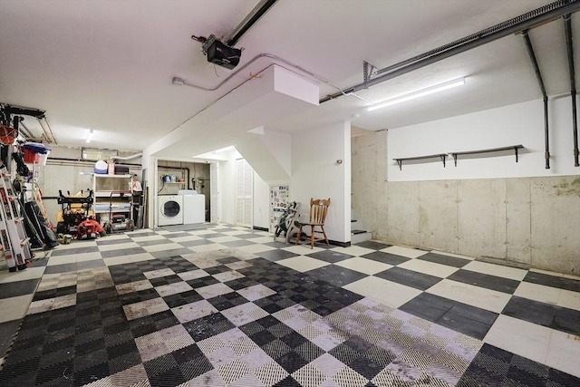 garage featuring separate washer and dryer and a garage door opener