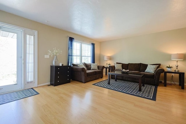 living area featuring light wood-style floors and baseboards