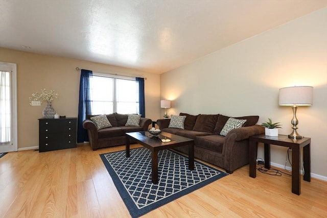 living room featuring light wood-style floors and baseboards