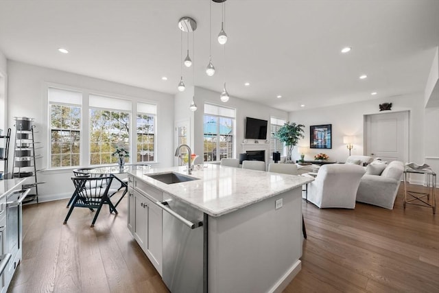 21 Snapping Bow, Plymouth, MA 02360 - kitchen featuring stainless steel dishwasher, recessed lighting, hanging light fixtures, wood finished floors, and light stone countertops