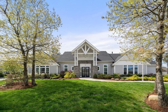 21 Snapping Bow, Plymouth, MA 02360 - view of front facade featuring a front yard, french doors, and board and batten siding