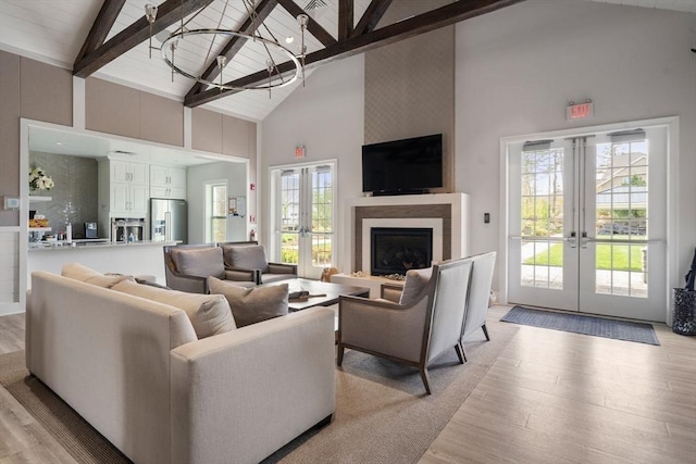 21 Snapping Bow, Plymouth, MA 02360 - living area with french doors, high vaulted ceiling, light wood-type flooring, a chandelier, and healthy amount of natural light