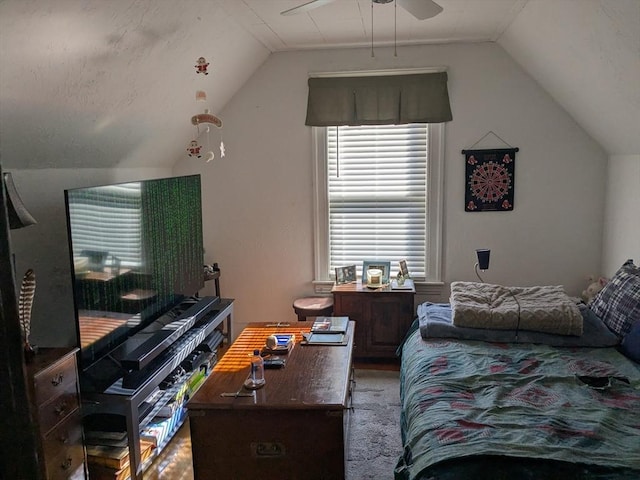 carpeted bedroom featuring a ceiling fan and vaulted ceiling