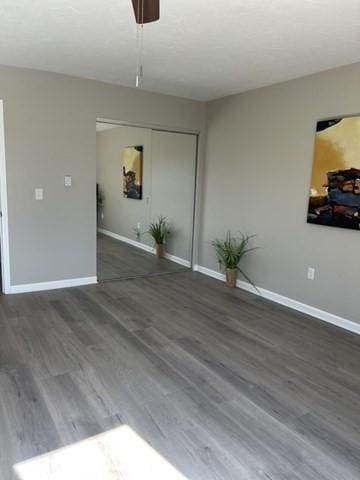 spare room featuring wood finished floors and baseboards