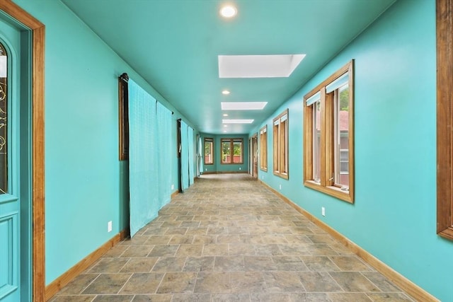 210 Plain Dr, Stoughton, MA 02072 - corridor with a skylight, stone finish flooring, and recessed lighting