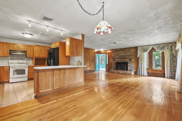 210 Plain Dr, Stoughton, MA 02072 - kitchen featuring white electric range oven, black refrigerator, under cabinet range hood, light countertops, and baseboard heating