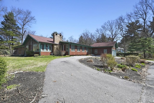 210 Plain Dr, Stoughton, MA 02072 - single story home with a chimney, asphalt driveway, and a front yard