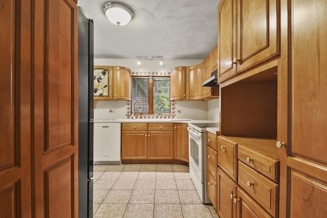 210 Plain Dr, Stoughton, MA 02072 - kitchen featuring white appliances, under cabinet range hood, light countertops, light tile patterned flooring, and track lighting