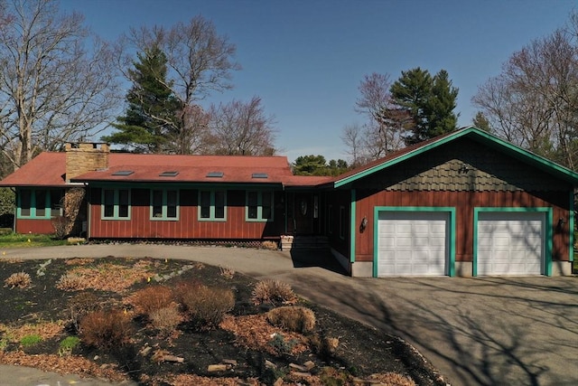 210 Plain Dr, Stoughton, MA 02072 - ranch-style home featuring asphalt driveway, a garage, and a chimney