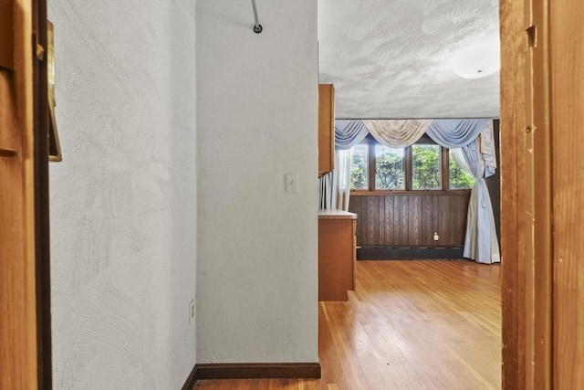 210 Plain Dr, Stoughton, MA 02072 - hall featuring wood finished floors, a textured wall, and a textured ceiling