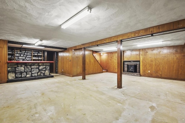 210 Plain Dr, Stoughton, MA 02072 - finished basement featuring a fireplace, a textured ceiling, and wooden walls