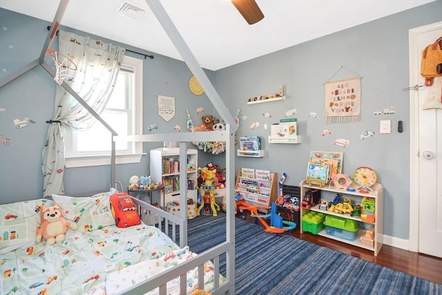 rec room featuring visible vents, baseboards, wood finished floors, and a ceiling fan