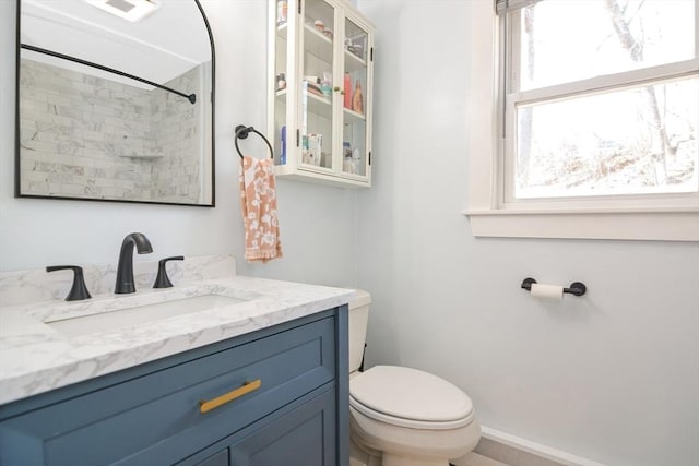 full bathroom featuring vanity, visible vents, baseboards, walk in shower, and toilet