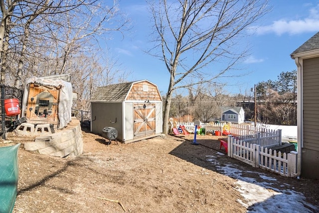 view of yard with fence, an outdoor structure, and a shed