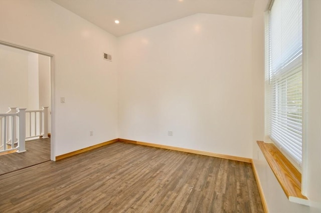 empty room featuring wood finished floors, baseboards, and recessed lighting