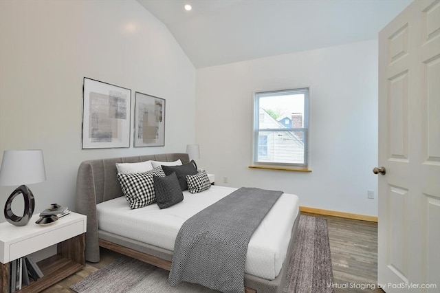 bedroom with lofted ceiling, wood finished floors, recessed lighting, and baseboards
