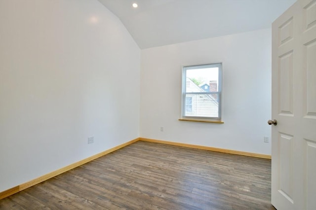 spare room with lofted ceiling, wood finished floors, baseboards, and recessed lighting
