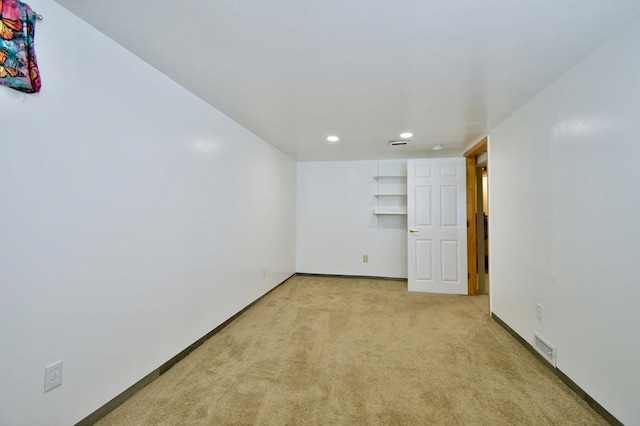 empty room with carpet floors, recessed lighting, and baseboards