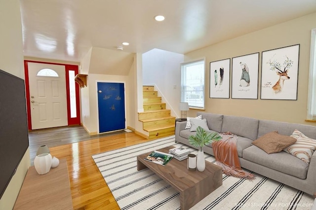 living area with stairway, recessed lighting, wood finished floors, and baseboards