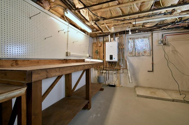 unfinished below grade area featuring tankless water heater and a workshop area
