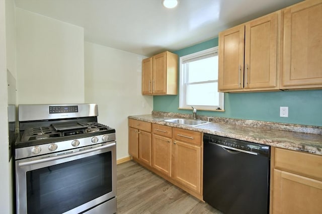 kitchen featuring black dishwasher, gas range, a sink, and light brown cabinetry
