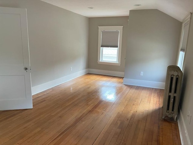 39 Barnard Rd, Worcester, MA 01605 - spare room featuring radiator heating unit, light wood-style flooring, and lofted ceiling