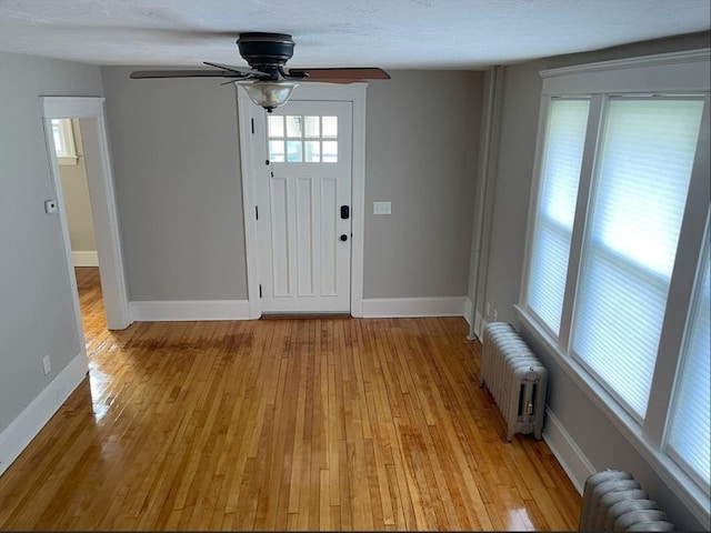 39 Barnard Rd, Worcester, MA 01605 - entryway with radiator, light wood-type flooring, a ceiling fan, and a textured ceiling