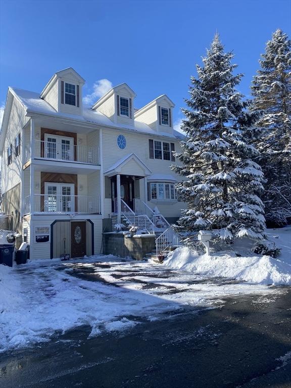 view of front of home featuring french doors and a balcony