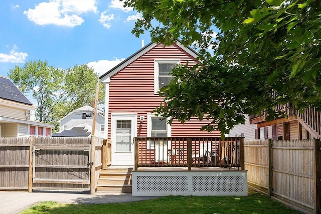 18 Doyle St, Lawrence, MA 01841 - rear view of property featuring a fenced backyard and a wooden deck