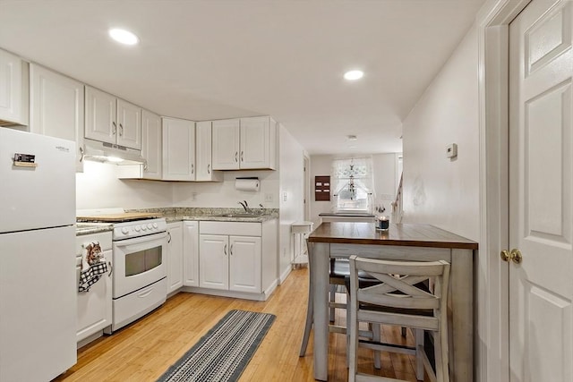 18 Doyle St, Lawrence, MA 01841 - kitchen featuring white appliances, under cabinet range hood, a sink, white cabinets, and light wood-style floors