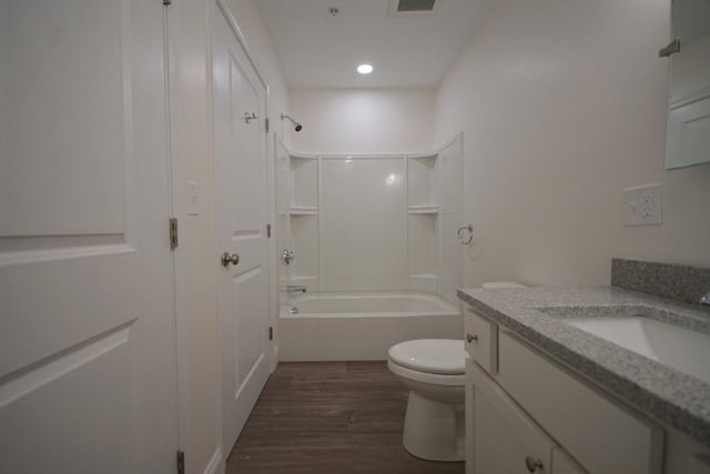 full bath featuring visible vents, toilet, vanity, wood finished floors, and  shower combination