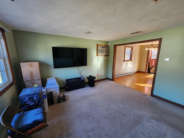 carpeted living room with an AC wall unit, a textured ceiling, and a baseboard radiator