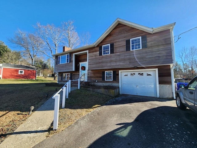 view of front of house featuring a garage and a front lawn