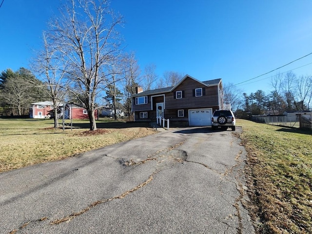 view of front of property featuring a garage and a front lawn