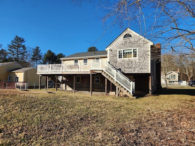 back of house with a lawn and a deck