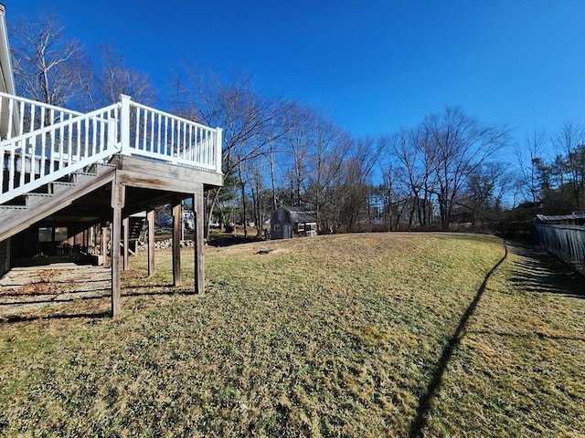 view of yard with a storage shed and a deck