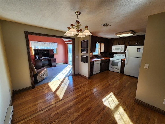 kitchen featuring a baseboard radiator, dark hardwood / wood-style floors, a notable chandelier, white appliances, and dark brown cabinets