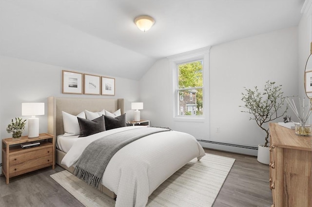 123 Ash St, New Bedford, MA 02740 - bedroom with baseboard heating, wood finished floors, and vaulted ceiling