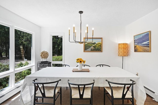 3 Down Harbor Rd, Edgartown, MA 02539 - dining space with a baseboard heating unit, a chandelier, and a textured ceiling