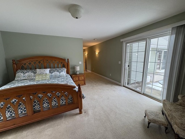 bedroom with access to outside and light colored carpet