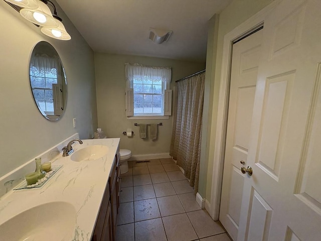 bathroom featuring vanity, tile patterned flooring, and toilet