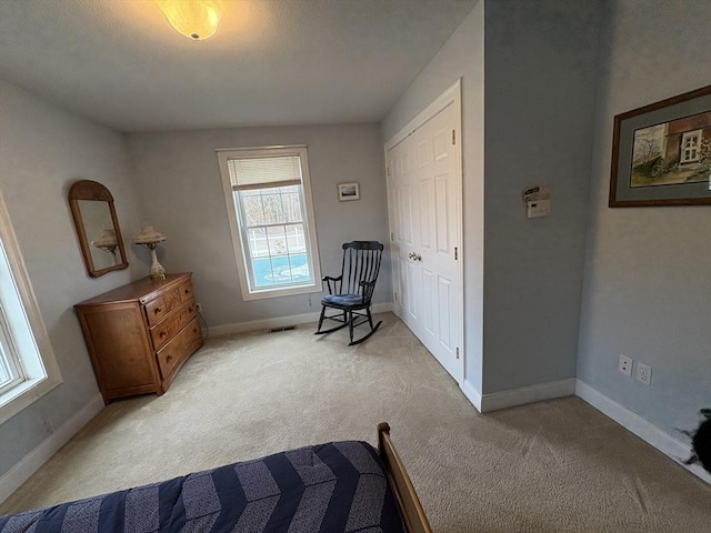 living area featuring light carpet