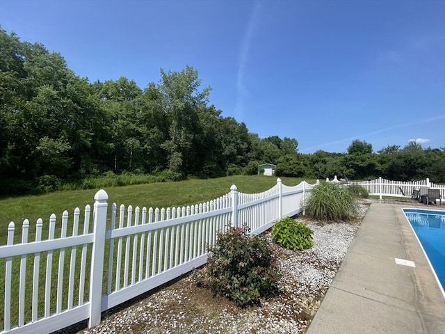 view of yard with a fenced in pool