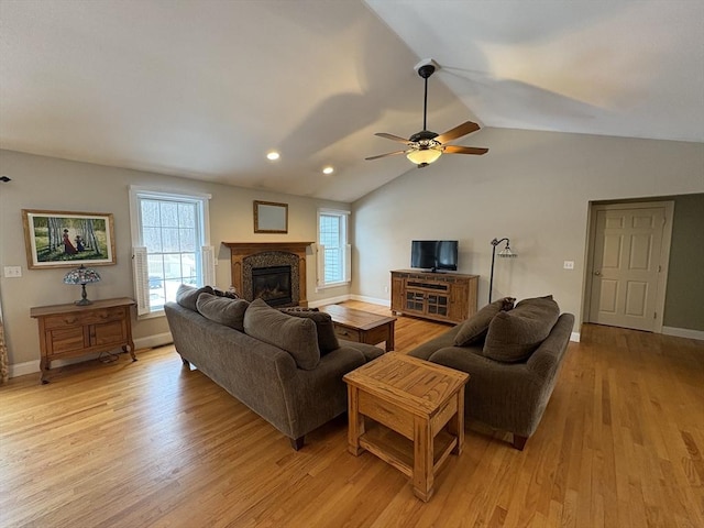 living room featuring ceiling fan, light hardwood / wood-style flooring, and a wealth of natural light