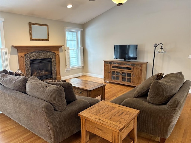 living room featuring light hardwood / wood-style flooring and lofted ceiling