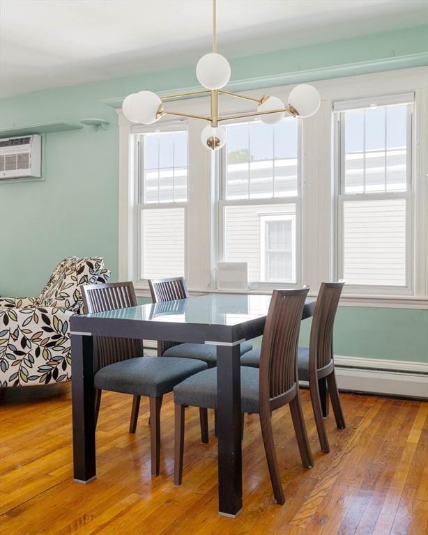 42 Lourdes Ave Unit 3, Boston, MA 02130 - dining area featuring plenty of natural light, a wall mounted AC, a baseboard heating unit, and light wood-type flooring